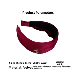 Detail showing dimensions of burgundy velvet headband with gold buckle and soft texture