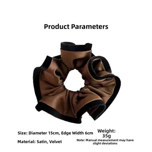 Detailed view of brown satin hair scrunchie with black velvet edges and size measurements