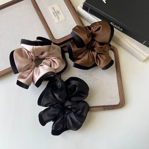 Three elegant satin scrunchies in champagne, caramel and black with velvet edging