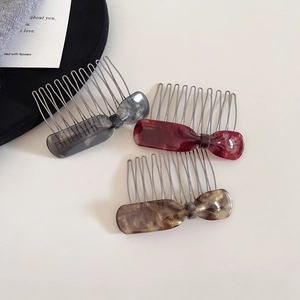 Three acetate hair combs set with tortoiseshell pattern in grey, red and golden brown