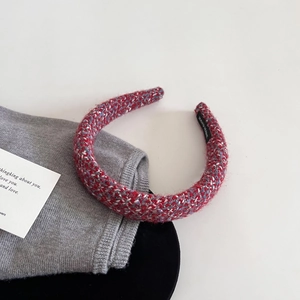 Detail of red and blue tweed headband texture with inner Hand Made label detail