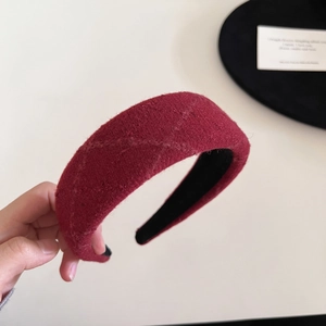 Detailed macro shot of dark red plaid woolen headband with textured stitch and non-slip lining