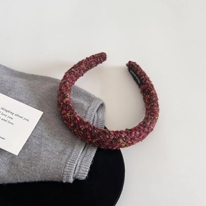 Detailed close-up of handmade tweed headband featuring multicolor woven wool texture