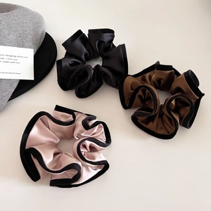 Three premium satin scrunchies with black velvet edges in black, coffee, and dusty rose