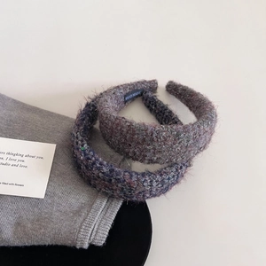 Detail of wide tweed headband set in purple and grey with soft sponge padding