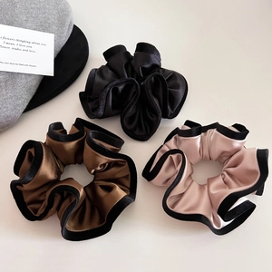 Detailed set of three velvet-edged satin hair scrunchies in black, coffee, and nude pink
