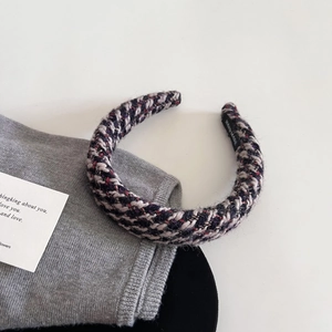 Detailed view of handmade tweed headband showing woven purple and grey texture with label