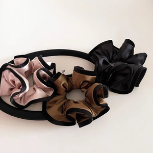 Three-piece set of satin scrunchies with black velvet edges in pink, bronze, and black