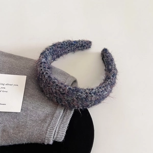 Macro detail of plush knit headband with silver sequins and soft grey-purple fuzzy texture