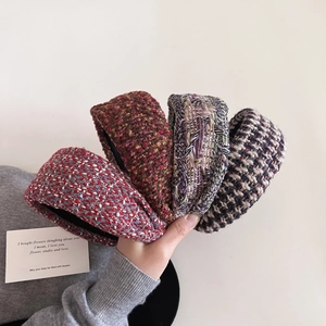 Detail of four textured tweed headbands in red, brown, and green vintage knit patterns