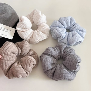 Detailed knit texture of Morandi color scrunchies in cream, blue, coffee and grey