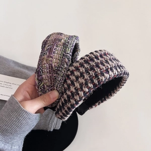 Detail showing two tweed wide headbands in purple and monochrome woven textures