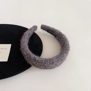 Close-up of handmade padded lilac bouclé headband with textured gold thread detail