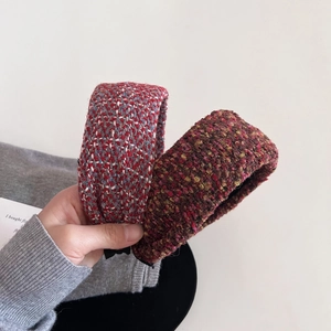 Close-up of thick tweed woven padded headbands in red and brown retro autumn styles