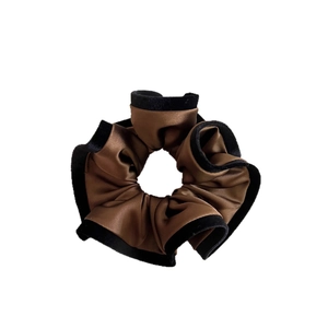 Elegant brown satin scrunchie with black velvet piping for high-end ponytail styling