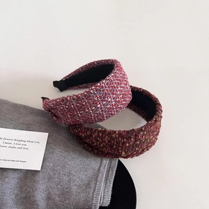 Detailed close-up of premium tweed wide headbands in red and brown textured fabric