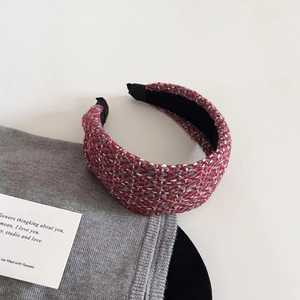 Detail of multi-color tweed woven headband with soft black inner lining and wide curved design