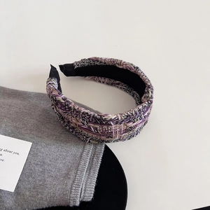 Detailed view of purple tweed headband texture with black non-slip inner lining