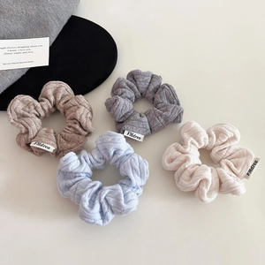 Minimalist knit scrunchie set in cream and blue with soft vertical ribbed texture