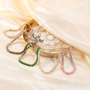 Luxurious tennis bracelets in five gem colors on a gold tray with silk background