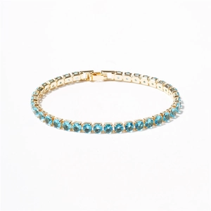 Elegant gold plated tennis bracelet featuring vibrant blue cubic zirconia stones