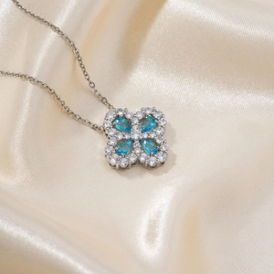 Elegant silver four-leaf clover necklace with blue pear-cut stones and white zircon