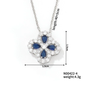 Macro detail of clover necklace with blue pear-cut stones and dimensions 1.9cm x 1.9cm