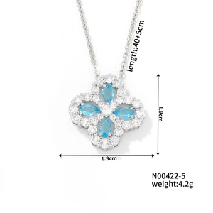 Detailed view of silver lucky four-leaf clover pendant with blue stones and dimensions