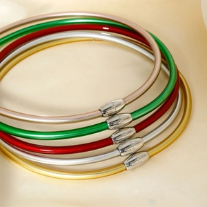 Set of five colorful silicone chokers with metallic finish and magnetic clasps on silk