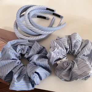 Detailed set of blue and white striped fabric headbands and scrunchies for hair styling
