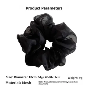 Detail view of black mesh scrunchie showing 18cm diameter and lightweight fabric texture