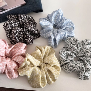 Five-piece set of Korean style floral scrunchies in various pastel colors on a white base
