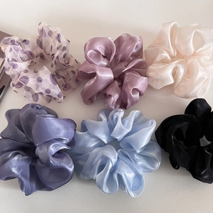 Detail view of six pearlized organza hair scrunchies in assorted pastel and dark colors