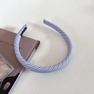 Close-up of blue and white striped fabric headband with a black non-slip inner lining