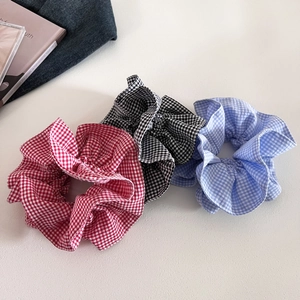 Detailed close-up of 3-piece set plaid scrunchies in red, black, and blue patterns