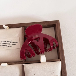 Vue détaillée de la pince à cheveux en acétate rouge foncé avec logo FRANCE Handmade