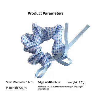 Detail view of blue checkered scrunchie with ribbon bow showing 12cm diameter size