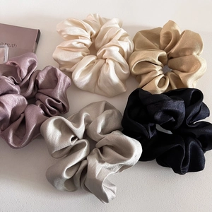 Set of 5 glossy satin silk scrunchies in pastel tones for versatile hair styling