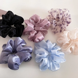 Flat lay of 6-piece satin and organza scrunchies set in pastel colors and polka dots