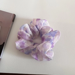 Elegant purple tie-dye chiffon scrunchie with soft ruffled texture and marble pattern