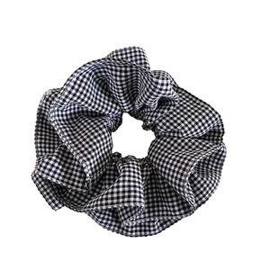 Gingham checkered fabric scrunchie in black and white pattern for hair styling