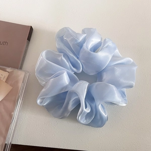 Macro shot of the light blue pearlescent organza scrunchie with soft ribbed texture