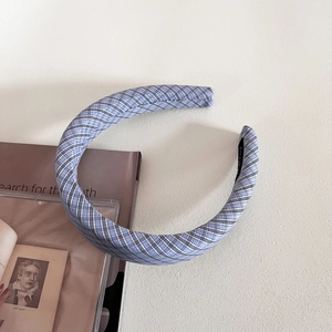Detailansicht eines dicken Schwamm-Haarreifens mit klassischem blau-weißem Karomuster