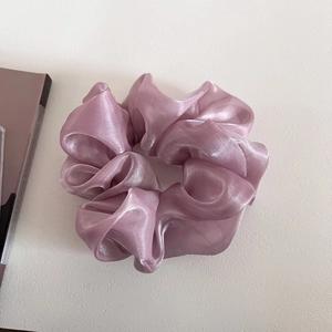 Detail of lavender pearlescent organza scrunchie with elegant pleated fabric texture