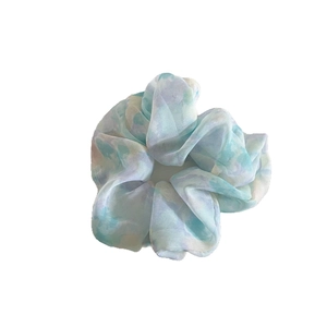 Elegant chiffon tie-dye scrunchie in soft macaron pastel colors for hair styling