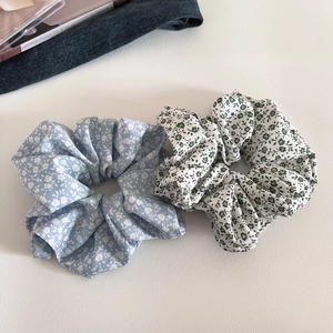 Floral print hair scrunchies in light blue and beige fabric for versatile styling
