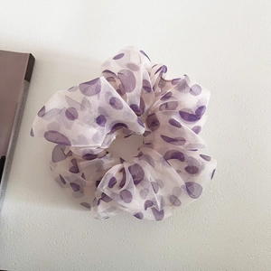 Macro detail of purple polka dot oversized scrunchie with soft organza texture