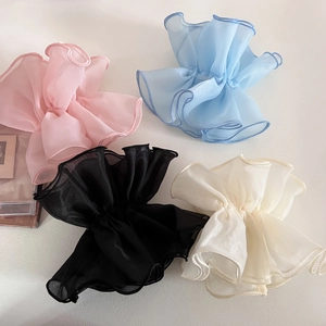 Detail showing oversized double-layered mesh hair scrunchies in four soft pastel colors