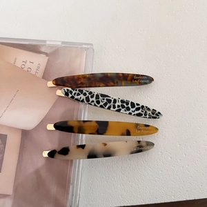 Set of four minimalist acetate hair clips with tortoiseshell and marble patterns