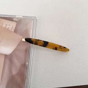 Detail of tortoiseshell acetate hair clip with Barrette La France gold lettering